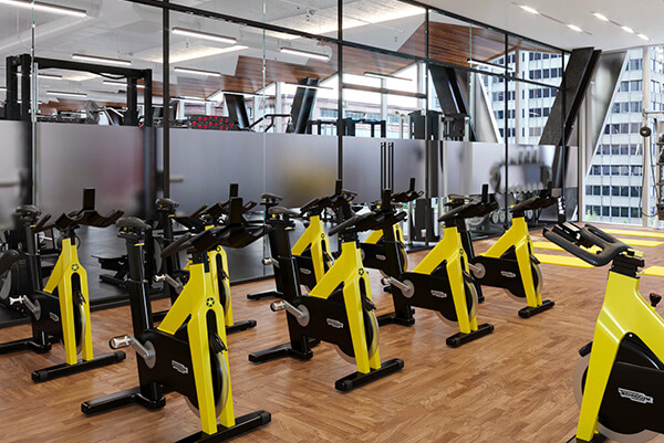 Yellow exercise bikes in 1111 South Tryon's onsite gym